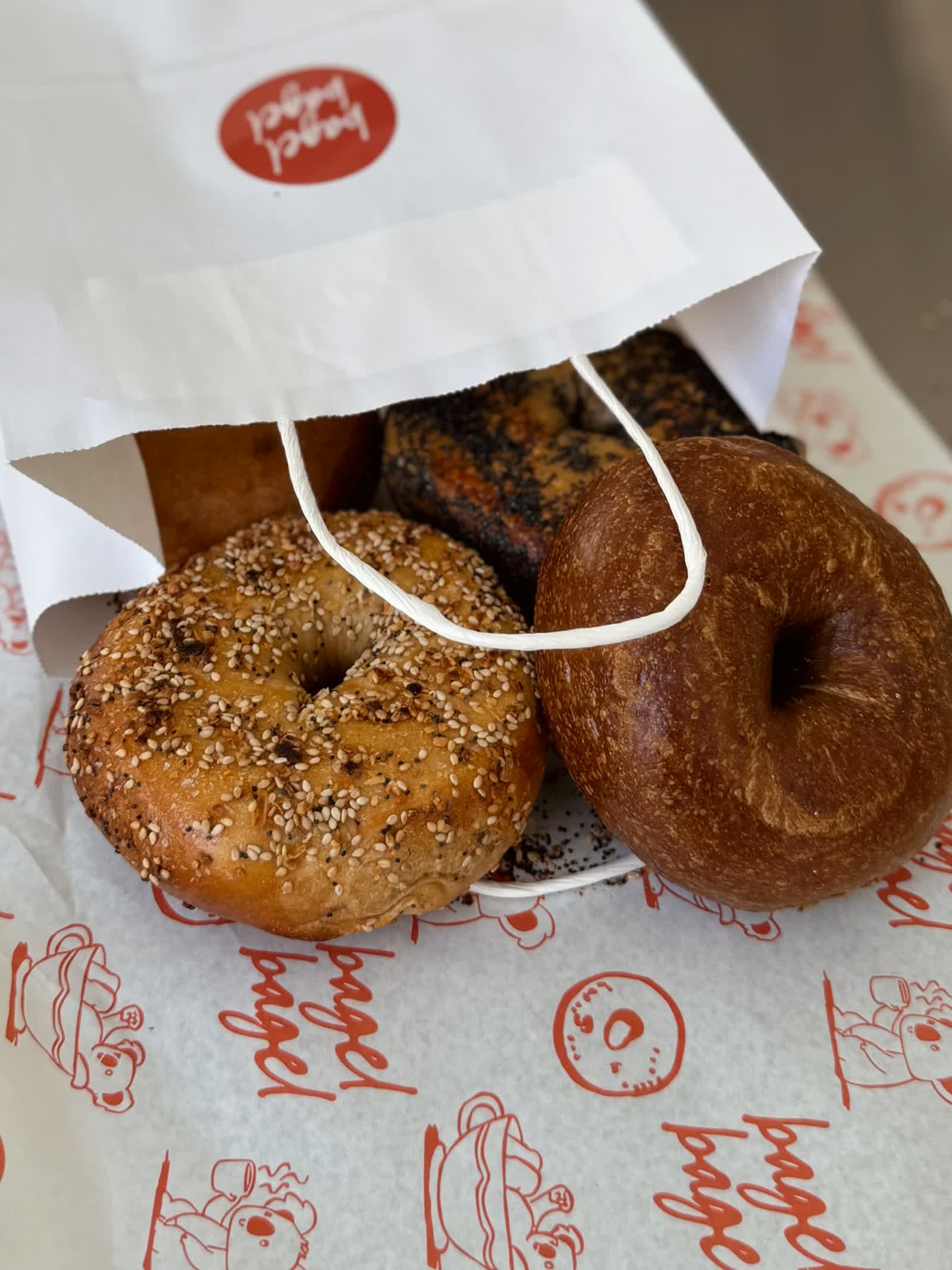 a bag of fresh bagels on branded paper