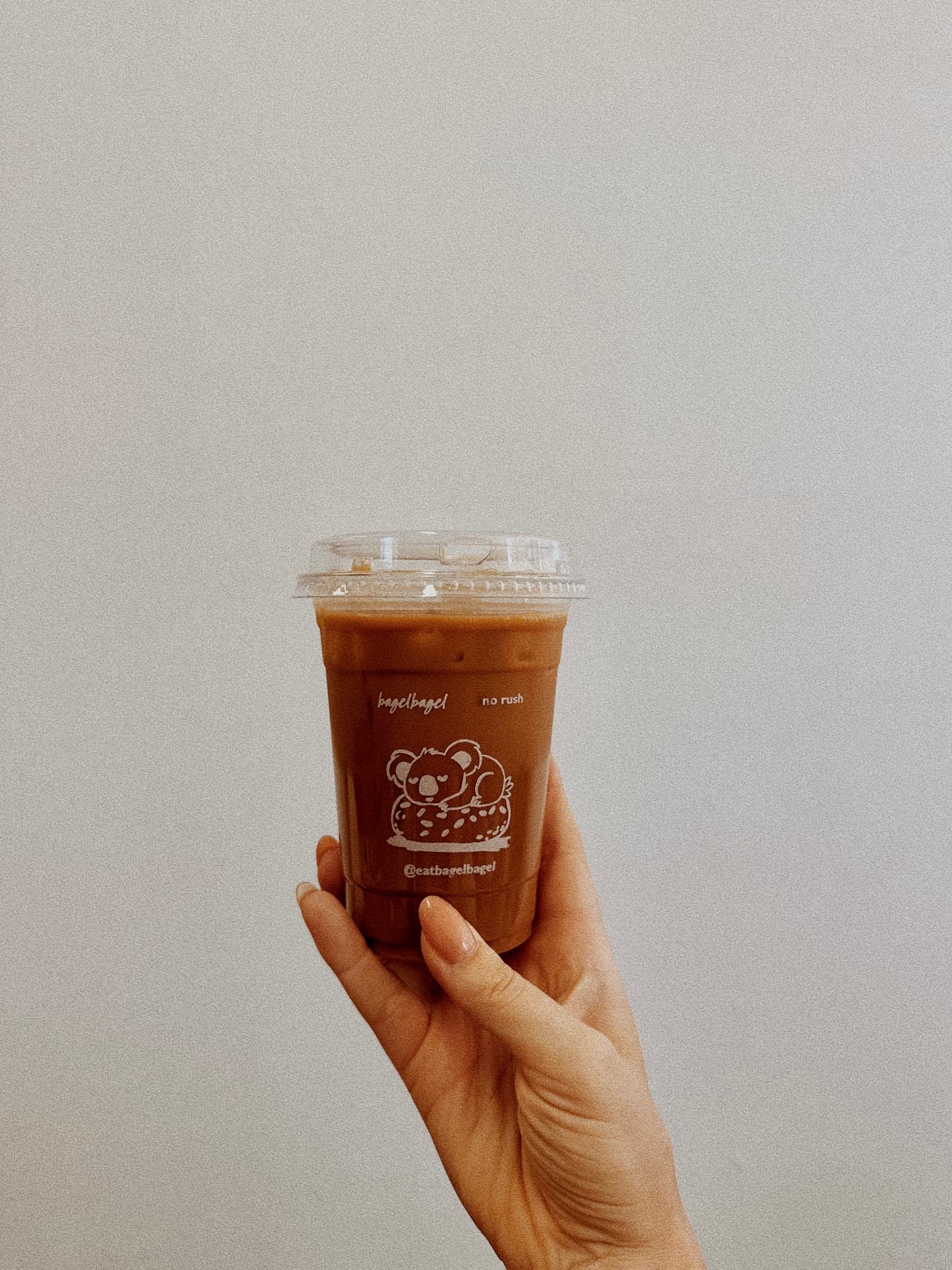 an iced coffee in a bagel bagel cup