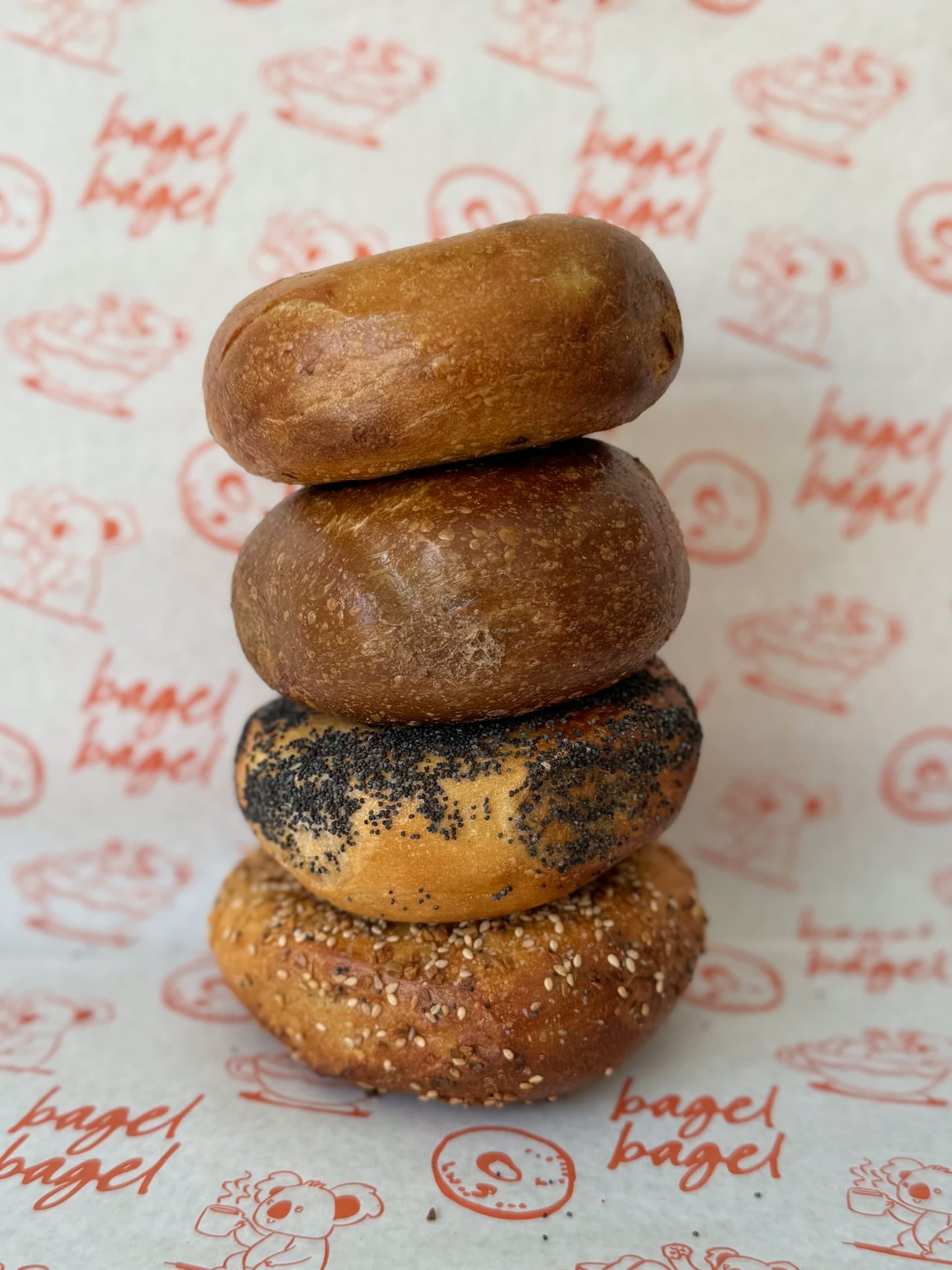 a stack of fresh bagel bagel bagels on branded wrapping paper